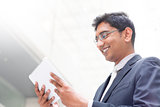  Indian businessman using digital tablet pc