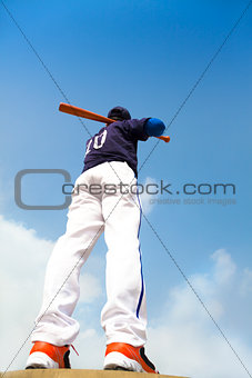  baseball player holding a bat  with blue sky