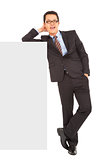 smiling businessman stand with blank wall