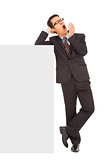 businessman yawning and standing  with blank board