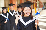 happy college graduate holding diploma  and make a gesture