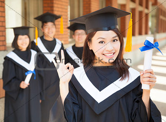 young college graduate holding diploma  and make a gesture