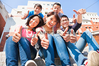  happy and smiling students thumbs up  together