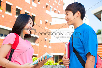 two students or friends are conversation happily 