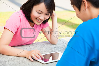 young girl using a tablet  with a friend or sweetheart