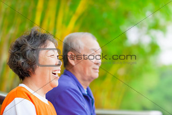 happy asian seniors in the park