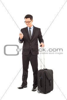 Young businessman holding a cell phone  with briefcase 