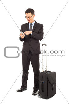 Young businessman using a cell phone  with briefcase 