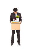 portrait of a fired businessman carrying a box