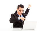  businessman yelling and make a fist with laptop
