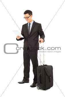 Young businessman holding a tablet  with briefcase 