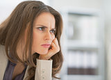 Portrait of frustrated business woman sitting in office