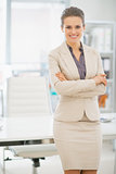 Portrait of smiling business woman standing in office
