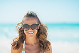 Portrait of young woman in sunglasses on beach