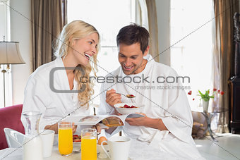Happy young couple having breakfast