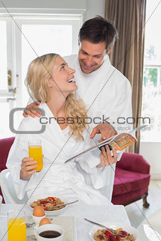 Couple looking at each other while having breakfast