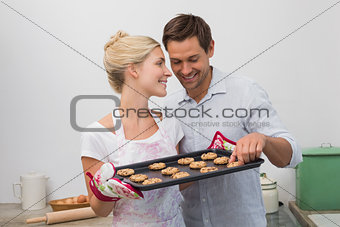 Couple preparing cookies together in kitchen