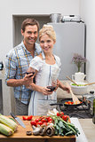 Loving young couple with wine glass in kitchen
