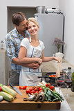 Young couple preparing food together in kitchen