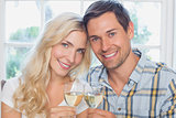 Happy loving young couple with wine glasses
