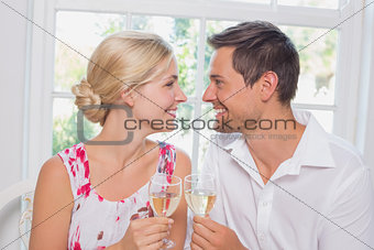 Loving couple with wine glasses looking at each other