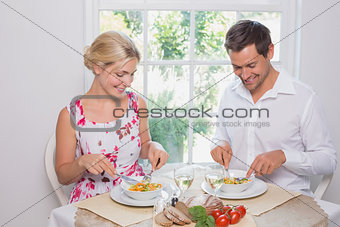 Happy young couple having food