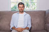 Portrait of a casual mansitting on sofa