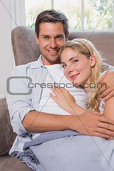Portrait of a relaxed loving couple lying on sofa