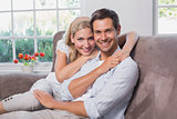 Portrait of relaxed loving couple sitting on sofa