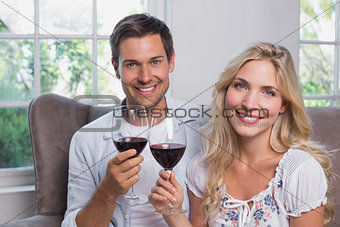 Young couple with wine glasses at home