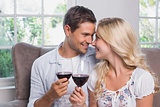 Loving young couple with wine glasses at home