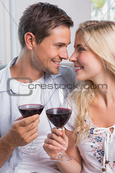 Loving young couple with wine glasses at home