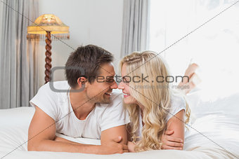 Relaxed casual young couple resting in bed