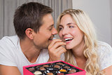 Relaxed happy couple eating candies