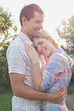 Smiling couple embracing in the park