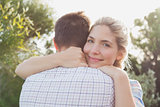 Smiling young couple embracing in park