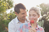 Young couple holding a flower in park
