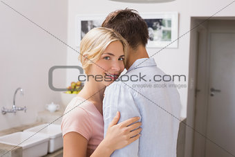 Side view portrait of a smiling couple embracing