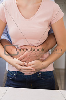 Man embracing woman from behind