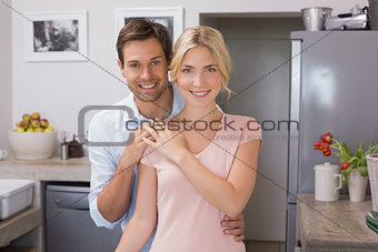 Portrait of a happy loving young couple in kitchen