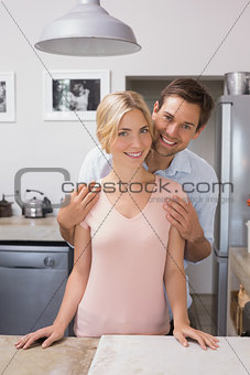 Happy loving young couple in the kitchen