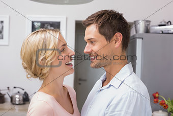 Loving couple looking at each other in the kitchen