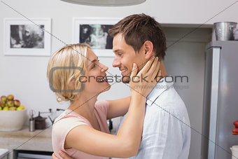 Loving couple looking at each other in kitchen