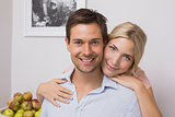 Woman embracing man from behind at home