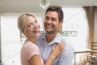 Cheerful loving young couple at home