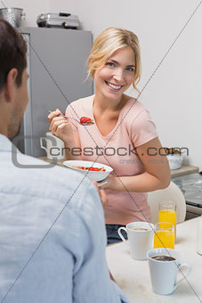 Young couple having breakfast at home