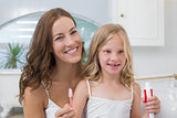 Mother and daughter with toothbrush and toothpaste