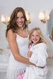 Happy mother and daughter in bathroom