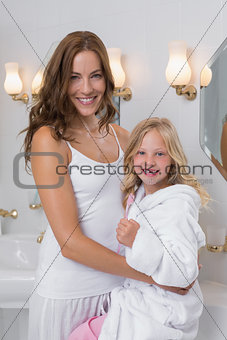 Happy mother and daughter in bathroom