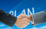 Composite image of business handshake against plan